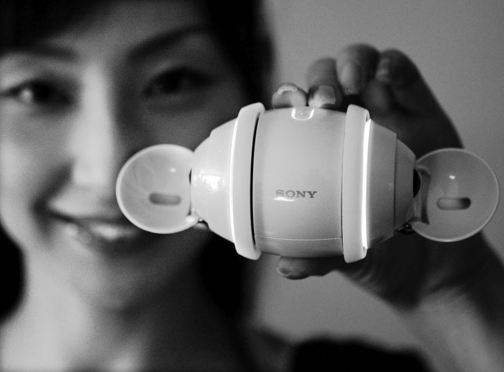 ROLLING ALONG – A model shows Sony Corp.’s new rolling egg-shaped digital music player swivels in Tokyo on Monday. The $354, 11 ounce Rolly, set to go on sale in Japan on Sept. 29, comes with stereo speakers, one gigabyte of internal flash memory and a battery good for about five hours of music. Overseas sales are still undecided. The smooth white gadget, small enough to sit on a palm, has sensors that recognize which way is up, allowing volume to be controlled by turning the player clockwise or counterclockwise, and tunes to be switched by pushing or pulling it on the floor.