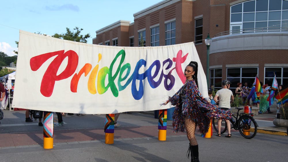 Drag artist Santana Sword poses by the Pridefest sign Aug. 27, 2022. Pridefest 2023 will be held Aug. 26 on Kirkwood Avenue. 