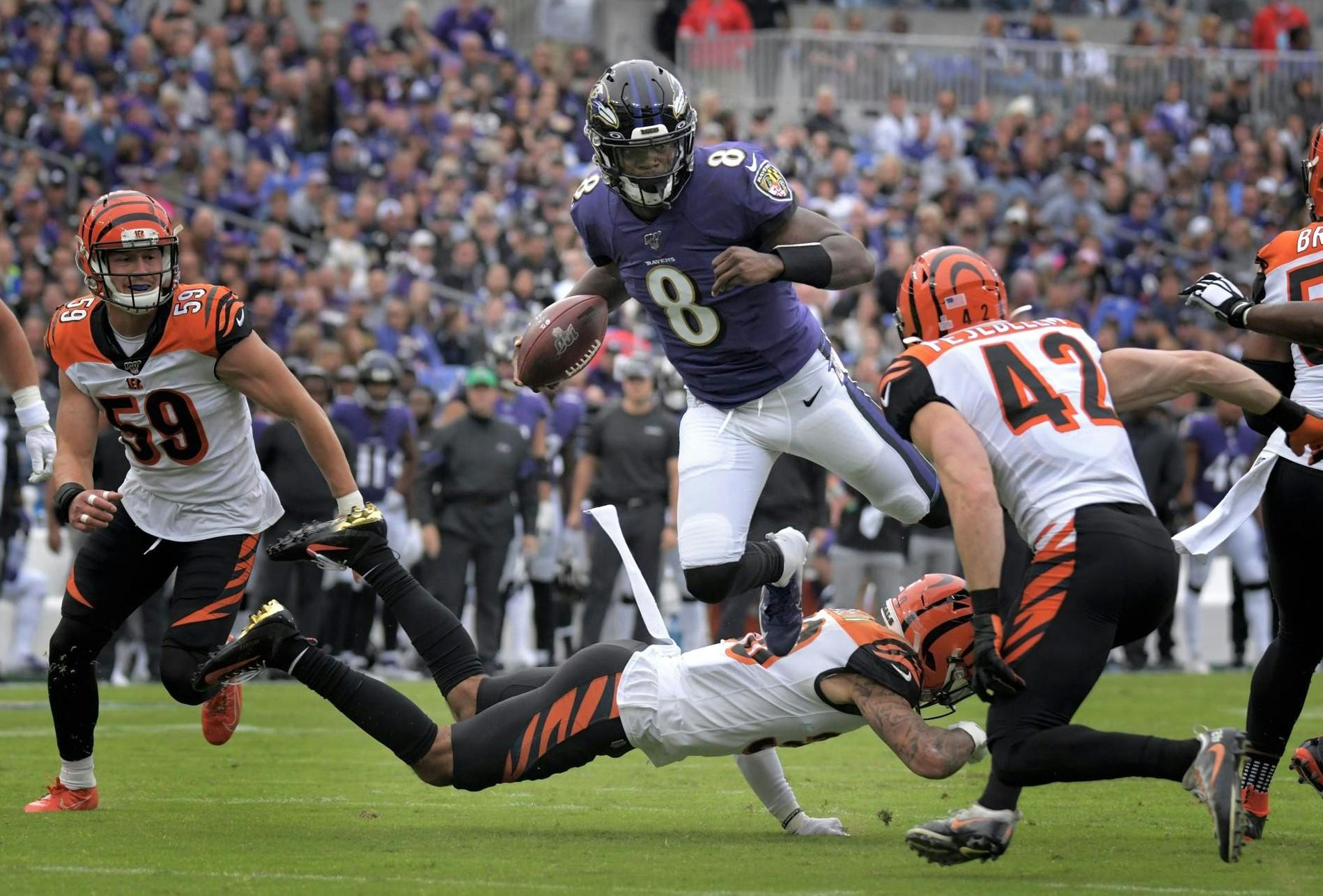 Cincinnati Bengals linebacker Nick Vigil watches Baltimore Ravens quarterback Lamar Jackson hurdle safety Jessie Bates III on Dec. 6 at M&T Bank Stadium in Baltimore, Maryland.