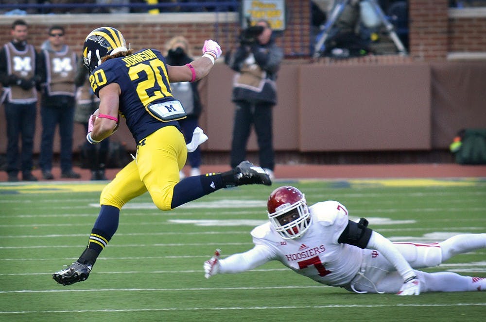 Freshman cornerback Donovan Clark tries to tackle Michigan running back Drake Johnson during IU's game against the Wolverines on Saturday at Michigan Stadium. Johnson scored two touchdowns on 122 yards rushing in IU's 34-10 loss.