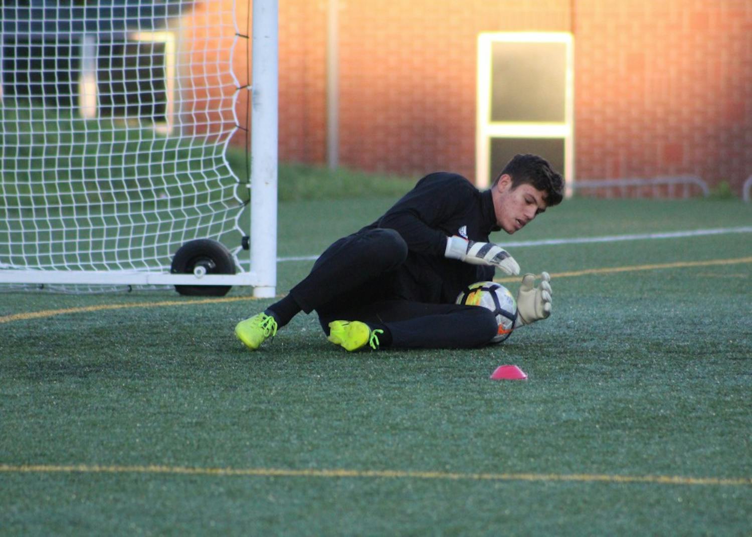 Freshman goalkeeper Trey Muse saves a shot during warm-ups before IU’s match against the Butler Bulldogs Oct. 18 in Indianapolis. Muse allowed no goals during the IU Credit Union/Adidas Classic.&nbsp;