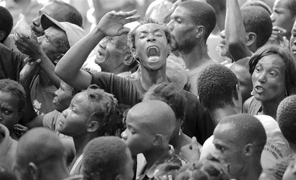 After the storm – A man screams as he waits in a crowd for food during a food distribution operation by the Yele Haiti foundation in Cabaret, Haiti, on Saturday. The U.N.’s World Health Organization is appealing for $4.2 million to help treat injured and sick Haitians in the wake of a devastating string of storms.