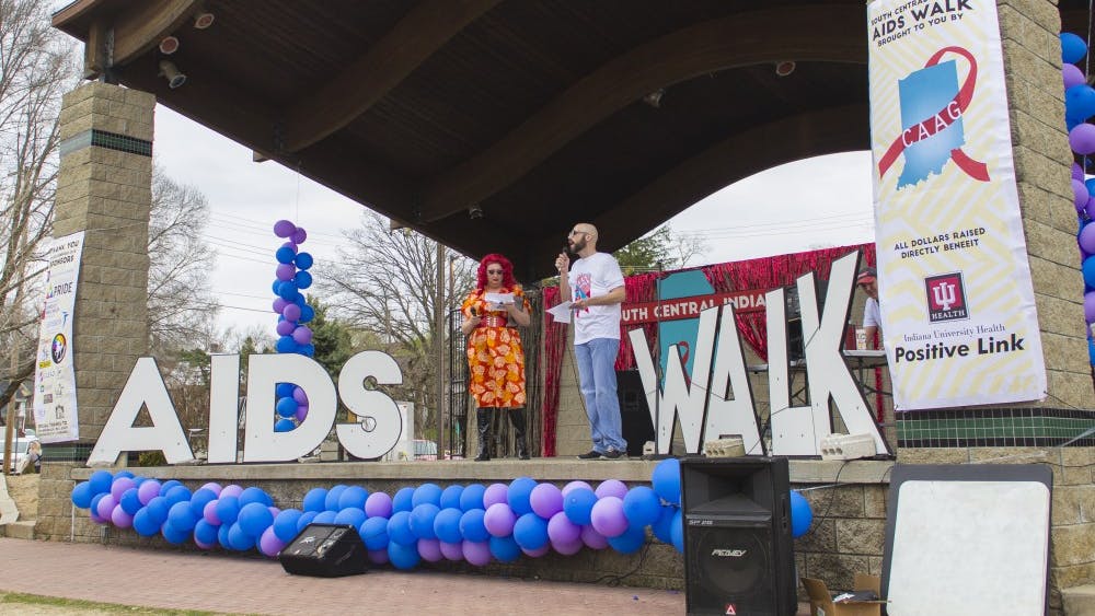 Argenta Peron and Jeremy Turner introduce the South Central Indiana AIDS Walk with opening remarks Friday at the Waldron Hill Buskirk Park. Peron flew in from Hawaii to participate in the event to raise awareness in the fight against AIDS.&nbsp;