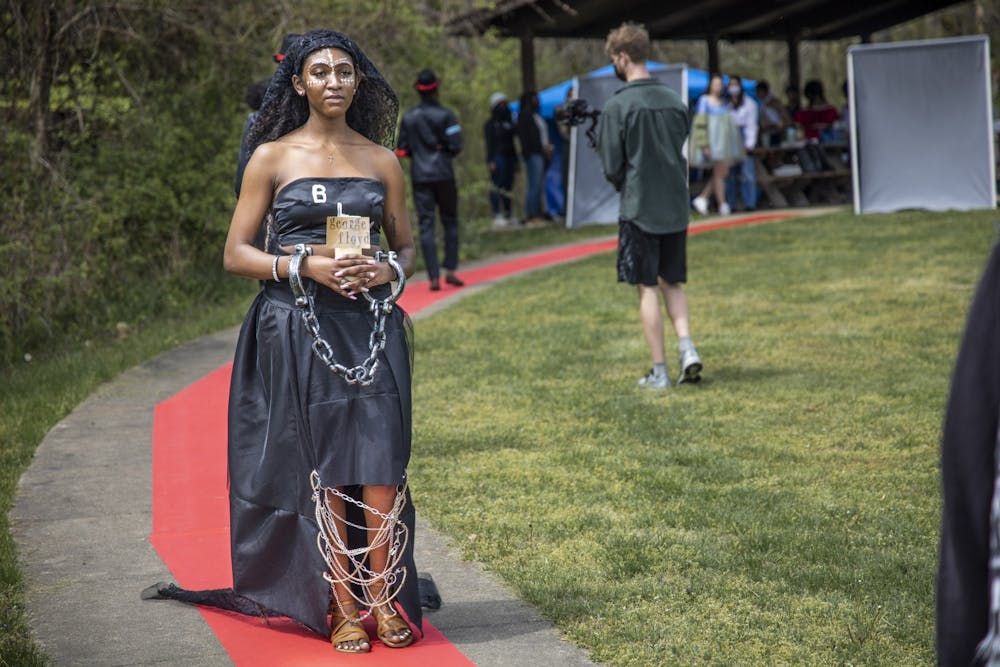 <p>Junior Mahogany Simpson walks down the runway wearing a dress designed and created by senior Deyjah Lee. The student-created fashion show was at 2 p.m. Sunday in Fairfax State Recreation Area.</p>