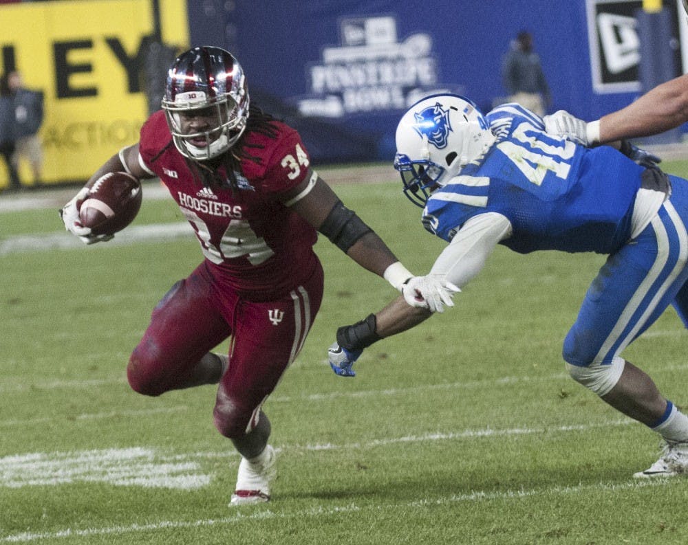 Running back Devine Redding attempts to evade Duke linebacker Dwayne Norman during the Pinstripe Bowl on Dec. 26, 2015 at Yankee Stadium.
