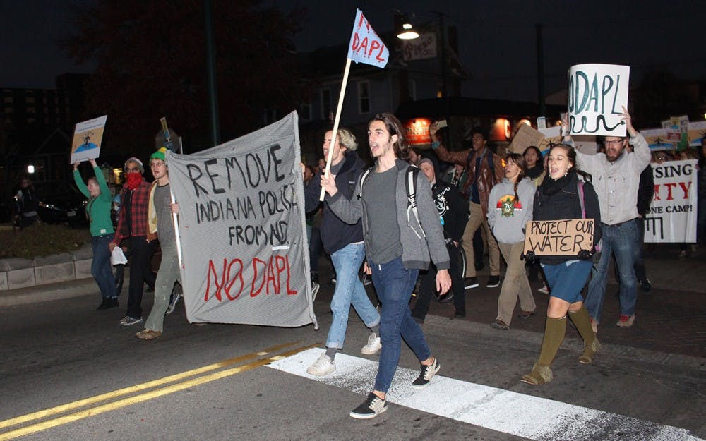 Protesters march down Kirkwood Avenue in protest of the Dakota Access Pipeline (DAPL) Tuesday night. The protest fell on the Day of Action, a national effort to protest the DAPL that included more than 200 planned organizations. 