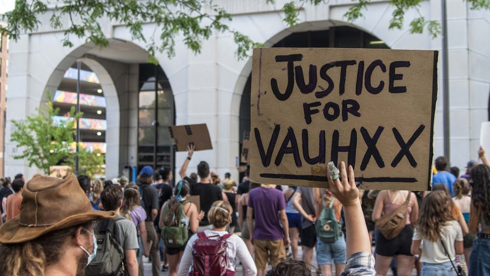 A protester holds up a sign July 6 in front of the Charlotte Zietlow Justice Center. Vauhxx Booker, a human rights advocate who is Black, reflected on a July 2020 incident at Lake Monroe on the one year anniversary of the encounter. 