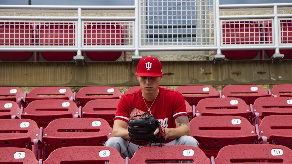 Sophomore pitcher Gabe Bierman looks down at his baseball glove Oct. 19, 2019, at Bart Kaufman Field. Bierman will play his second consecutive season for IU in 2020. 