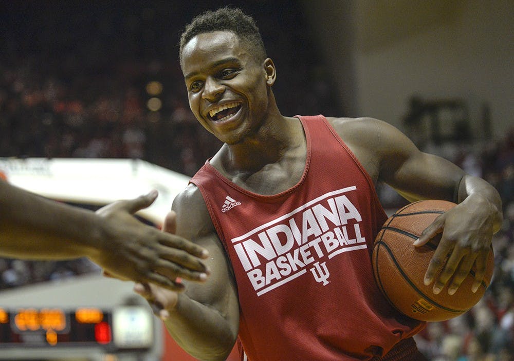Junior Kevin "Yogi" Ferrell high-fives sophomore Devin Davis before the dunk contest on Oct. 25 during Hoosier Hysteria at Assembly Hall.