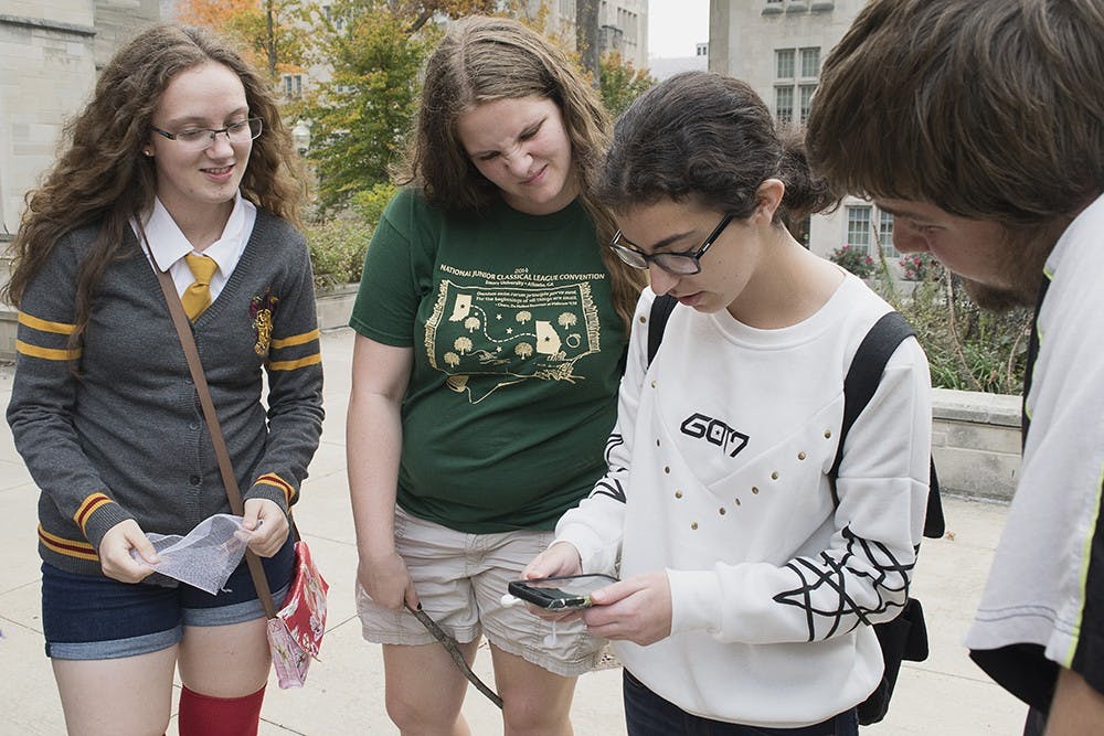 Hufflepuff house members puzzle over a clue during a campus-wide scavenger hunt Sunday evening put on by the Harry Potter Society. Club members searched campus for hidden horcruxes to complete the challenge. 