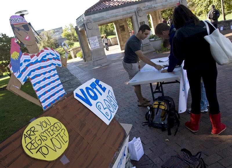 Senior Jason Fried helps students register to vote at INPIRG's "Vote Boat" Thursday outside the arboretum near the intersection of 10th Street and Fee Lane. With the vast effort by several student groups in the last few weeks, INPIRG volunteers wanted to do something different to attract potential voters.