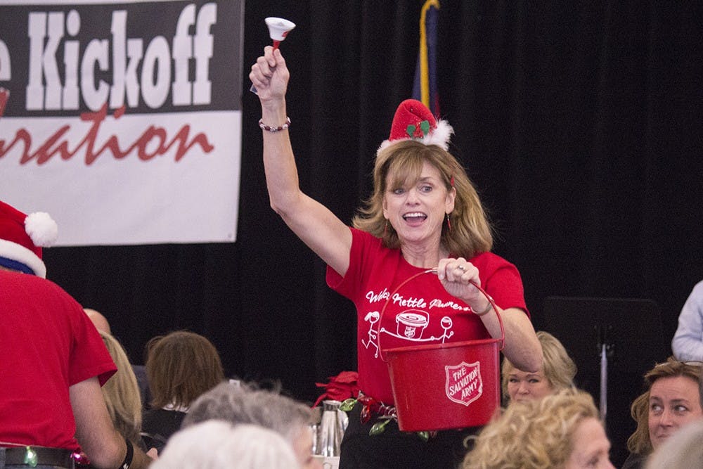Peggy Welch runs around collecting money during the Salvation Army's Dash for Cash at the Kettle Kick-off on Monday. Welch was part of the winning team for this part of the event.