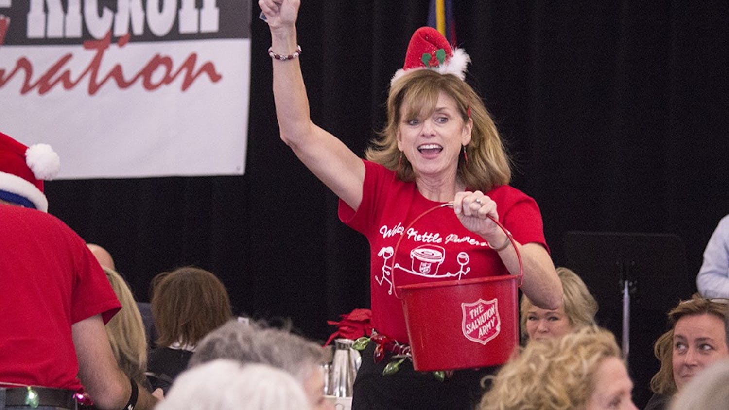 Peggy Welch runs around collecting money during the Salvation Army's Dash for Cash at the Kettle Kick-off on Monday. Welch was part of the winning team for this part of the event.