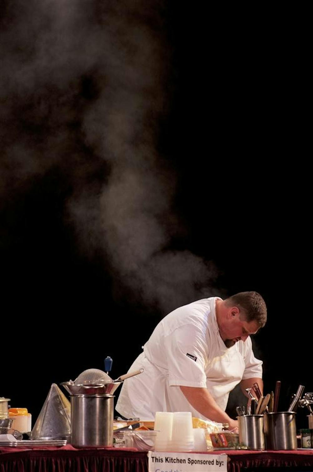 Dave Tallent, executive chef of Restaurant Tallent, prepares food during Bloomington's fourth annual Chefs' Challenge on Sunday at the Burskirk-Chumley Theater. Tallent, who won the one-hour cooking competition and its "Golden Spatula" award for the second year in a row, battled against representatives from two other restaurants in front of a live audience.