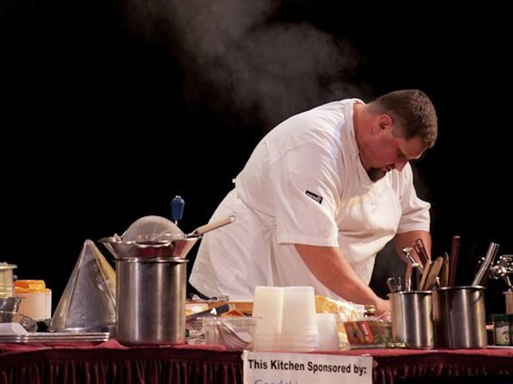 Dave Tallent, executive chef of Restaurant Tallent, prepares food during Bloomington's fourth annual Chefs' Challenge on Sunday at the Burskirk-Chumley Theater. Tallent, who won the one-hour cooking competition and its "Golden Spatula" award for the second year in a row, battled against representatives from two other restaurants in front of a live audience.