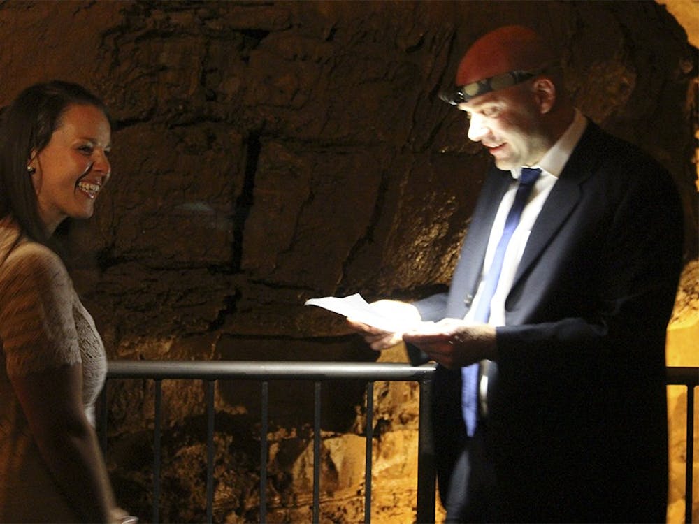 Bride Goniela Barcom and bridal Brad Barcom have their wedding at the Binkley Cave on Saturday, October 17, 2015. They use headlamps to read their love letters to each other.