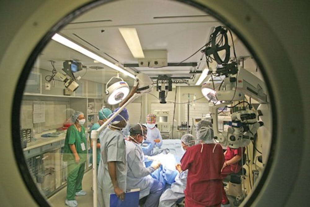 COURTESY PHOTOIU School of Medicine professor and retina specialist Dr. Hua Gao performs surgery on a plane as part of ORBIS international, a non-profit orgainization otherwise known as the Flying Eye Hospital.