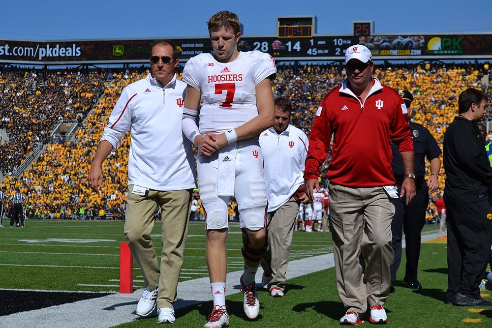 Junior quarterback Nate Sudfeld walks off the field after being injured during IU's game against Iowa on Saturday at Kinnick Stadium in Iowa City, Iowa.