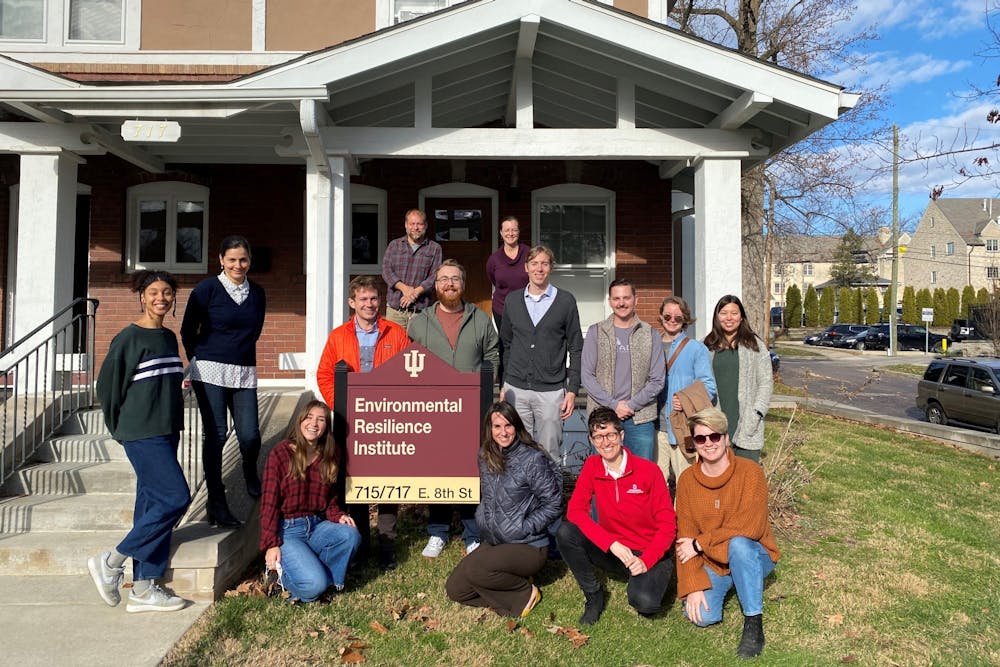 <p>IU Environmental Resilience Institute staff pose for a photo in December 2021 during a holiday gathering at the ERI house on campus. Founded in 2017 with a grant from the McKinney Family Foundation, the McKinney Midwest Climate Project gives students the skills necessary to work with cities and organizations by identifying and reducing greenhouse gas emissions.</p>