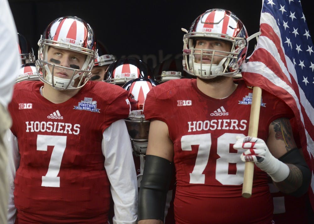 Quarterback Nate Sudfeld and offensive tackle Jason Spriggs lookup to the crowd before being running onto the field before the Pinstripe Bowl against Duke on Dec. 26 at Yankee Stadium.