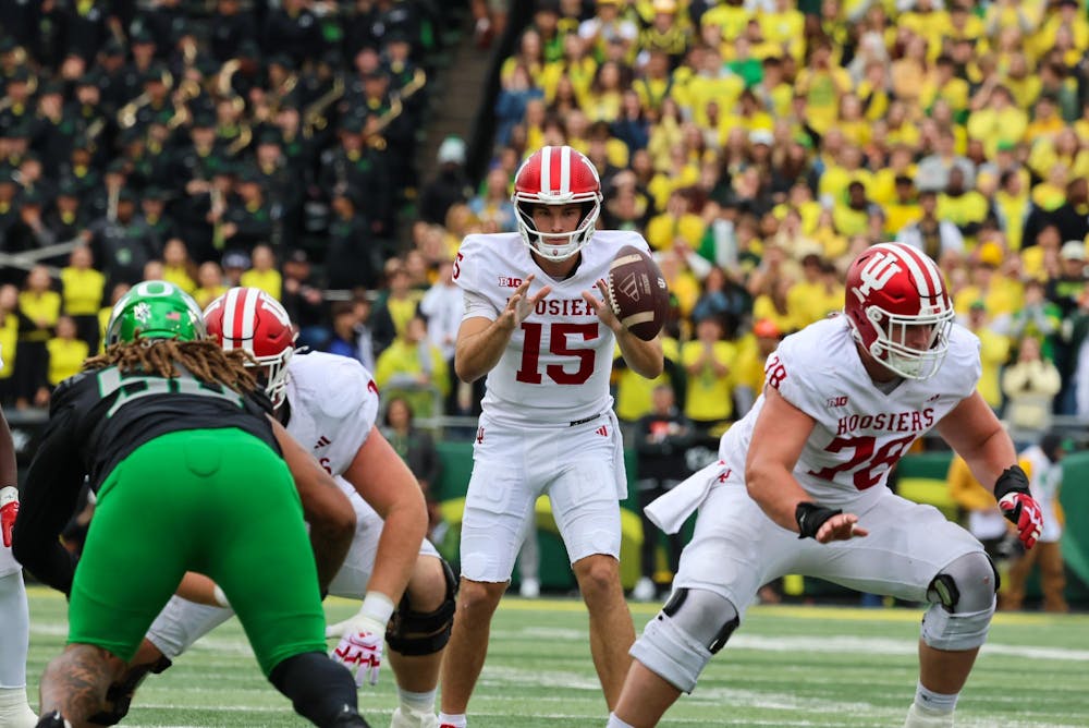 Indiana redshirt junior quarterback Fernando Mendoza catches the snap during the IU versus Oregon game at Autzen Stadium on Oct. 11. Mendoza had 215 passing yards during the game against the Ducks. 