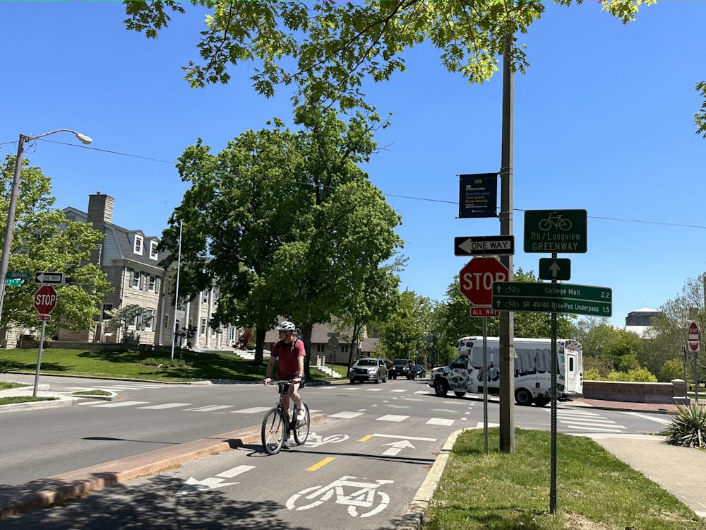 A bicyclist is seen on the Seventh and Longview Greenway May 5, 2023, crossing the intersection of Seventh Street and Indiana Avenue. This is one of the neighborhood greenways implemented by the city, meant to slow vehicle speeds and increase pedestrian and cyclist traffic.