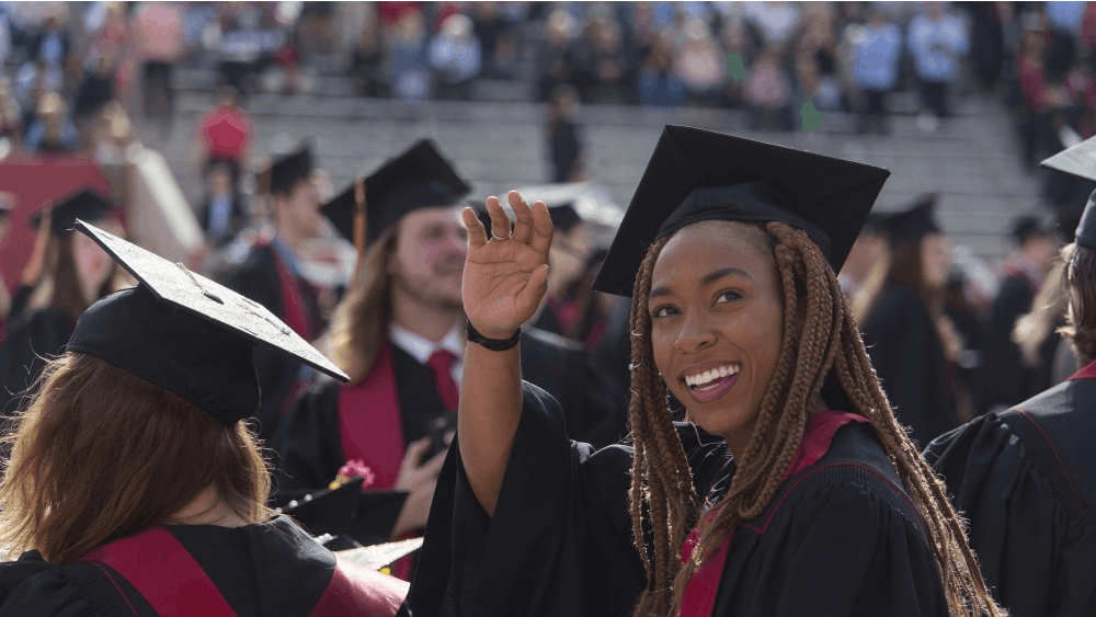 A student waves to the audience before the start of the 2018 undergraduate commencement ceremony Saturday, May 5, at Memorial Stadium. IU awarded 9,844 degrees over the weekend to students from all 50 states.&nbsp;
