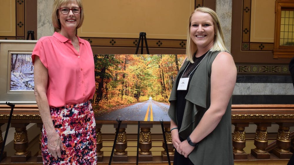 Artist Alina Davis poses with one of her works, titled "The Yellow Brick Road," at a previous Hoosier Women Artists Contest. Submissions for the 2018 Hoosier Women Artists Contest are due Friday, Jan. 26.