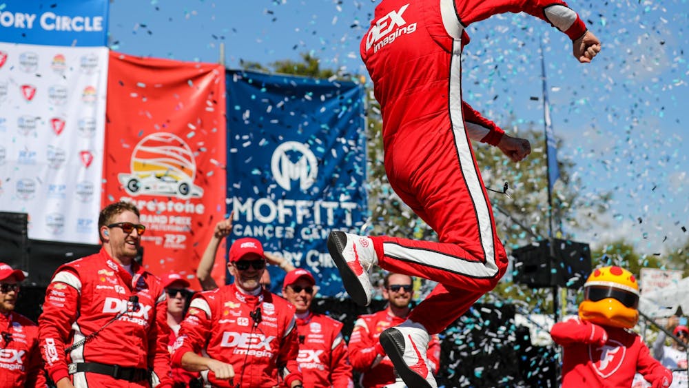 Team Penske IndyCar driver Scott McLaughlin celebrates after winning the Firestone Grand Prix of St. Petersburg on Feb. 27, 2022, in St. Petersburg, Florida. It was McLaughlin&#x27;s first win in the NTT IndyCar Series and required holding off defending series champion Alex Palou.