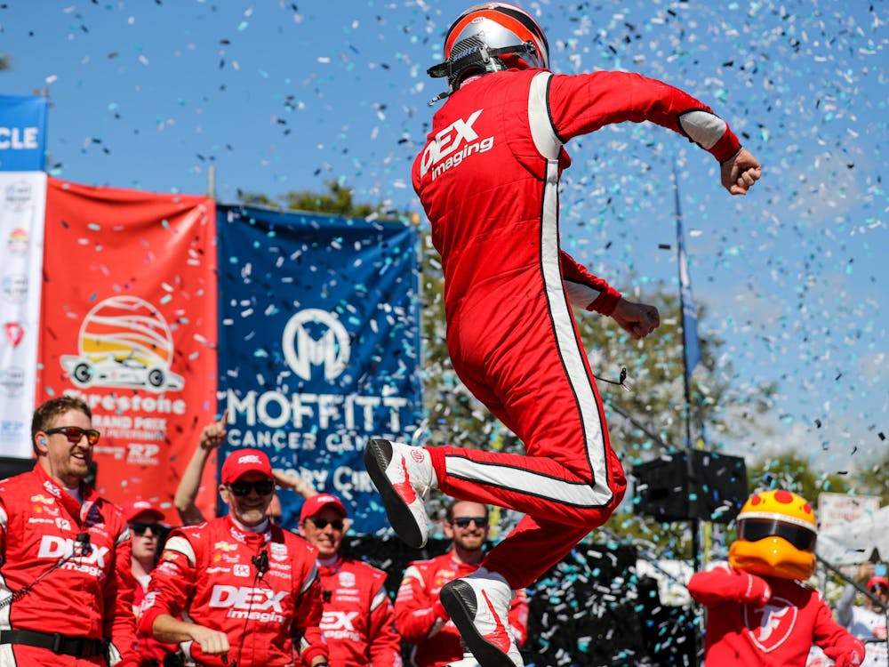 Team Penske IndyCar driver Scott McLaughlin celebrates after winning the Firestone Grand Prix of St. Petersburg on Feb. 27, 2022, in St. Petersburg, Florida. It was McLaughlin&#x27;s first win in the NTT IndyCar Series and required holding off defending series champion Alex Palou.