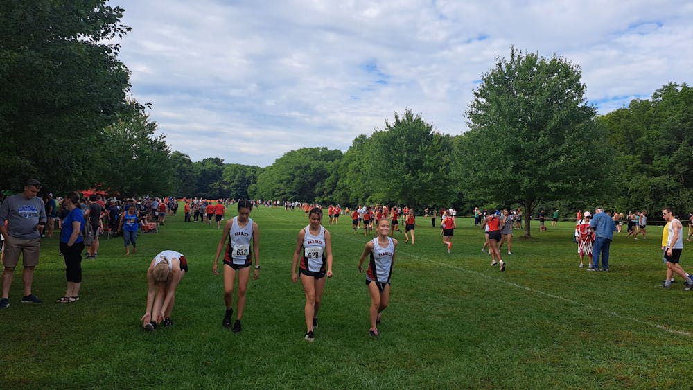 Runners do their final stretches Sept. 3, 2022, as they prepare to race at the Harrison Invitational in West Lafayette. Even though Isabella Vesperini hasn&#x27;t run a cross country race since high school, she still gets emotional at meets.