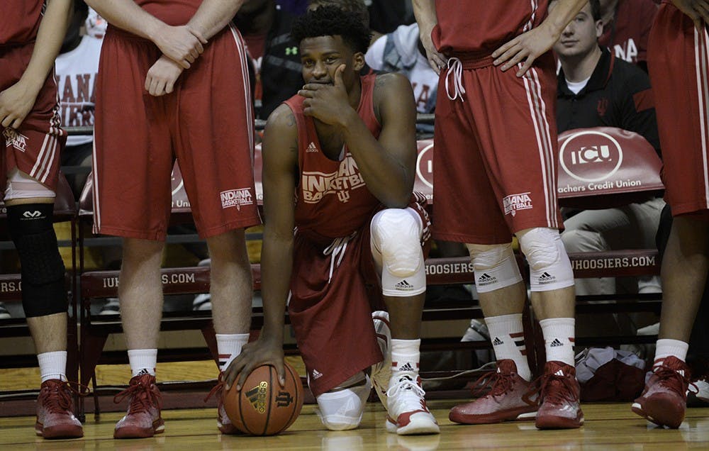 Sophomore Stanford Robinson watches the dunk contest from the sidelines Saturday during IU's Hoosier Hysteria at Assembly Hall.