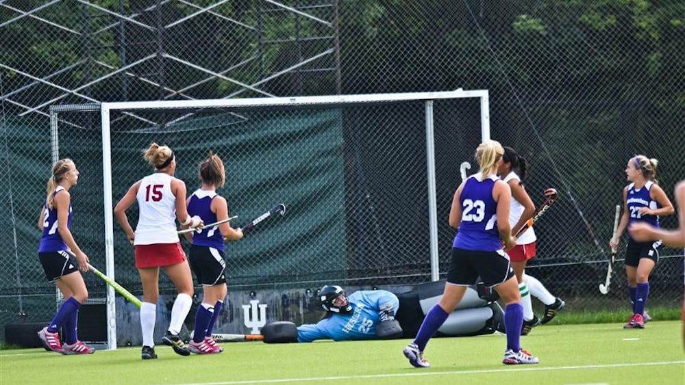 Freshman goalkeeper Maggie Olson dives to block a shot during IU's 4-1 victory against Northwestern on Friday at the IU Field Hockey Fields.