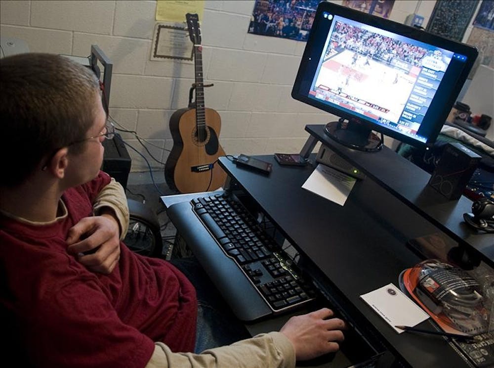 Junior A.J. Moir plays on his new computer Tuesday afternoon in his basment after winning a Microsoft contest to pimp out his apartment with technology.
