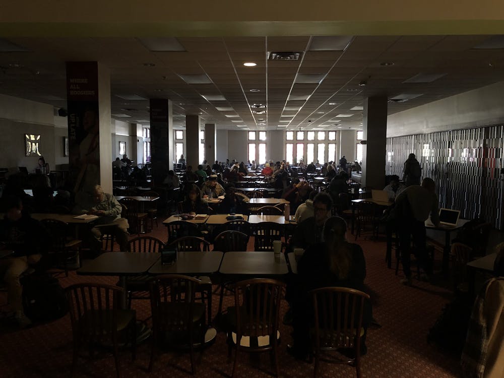 Students sit during a power outage Nov. 8 at the Indiana Memorial Union. The power outage affected many buildings across campus.