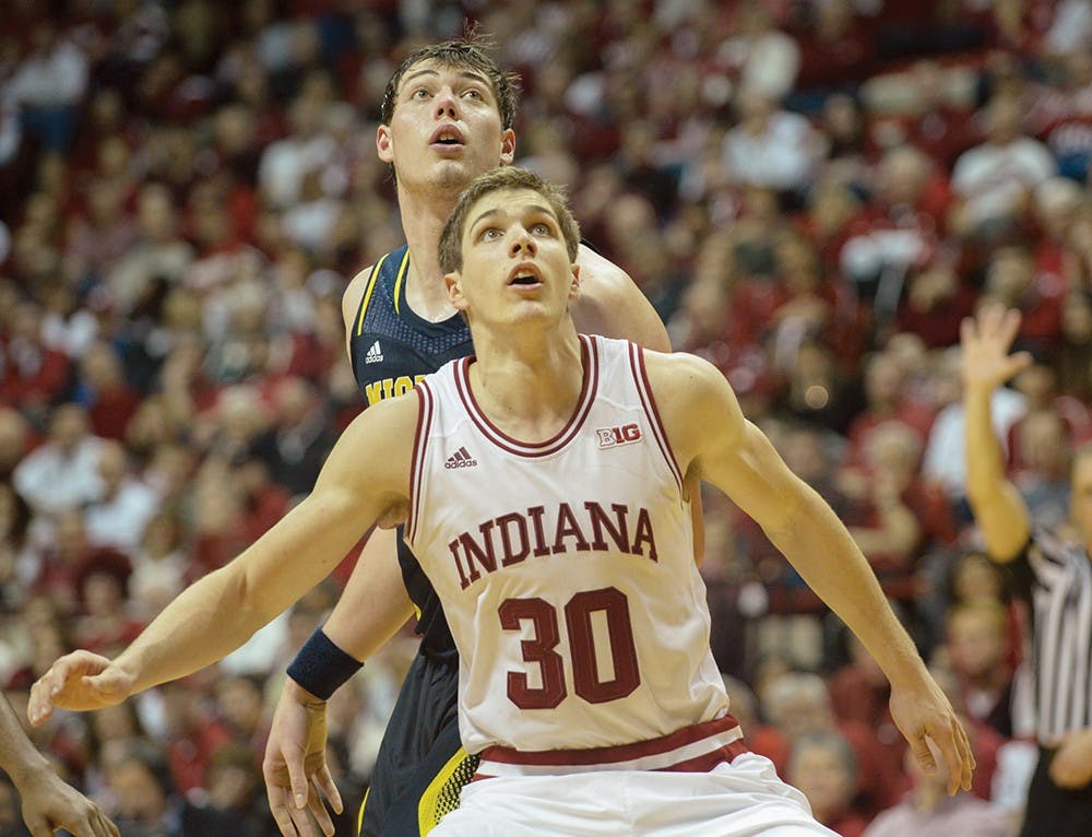Sophomore forward Colin Hartman boxes out a Michigan opponent during the game on Sunday at Assembly Hall.