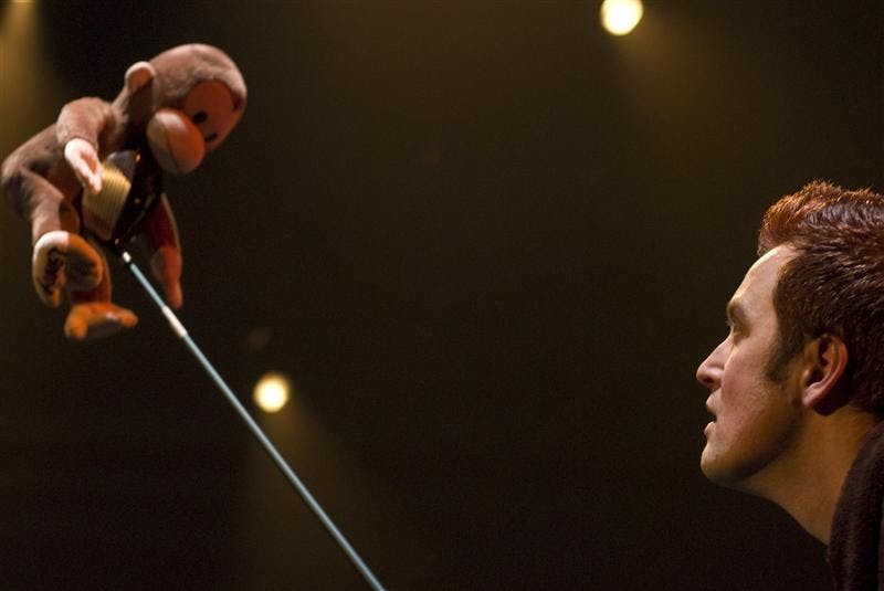 MFA actor Henry A. McDaniel III balances a Curious George stuffed animal on a golf club prop before a dress rehearsal of the urban drama ‘Marisol.’ McDaniel plays the role of Lenny for the performances, which continue running today through Saturday in the Wells-Metz Theatre.
