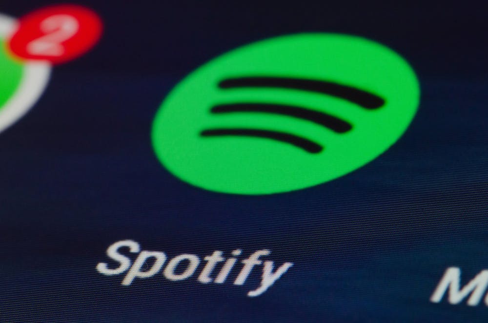The Spotify app is seen on a screen.