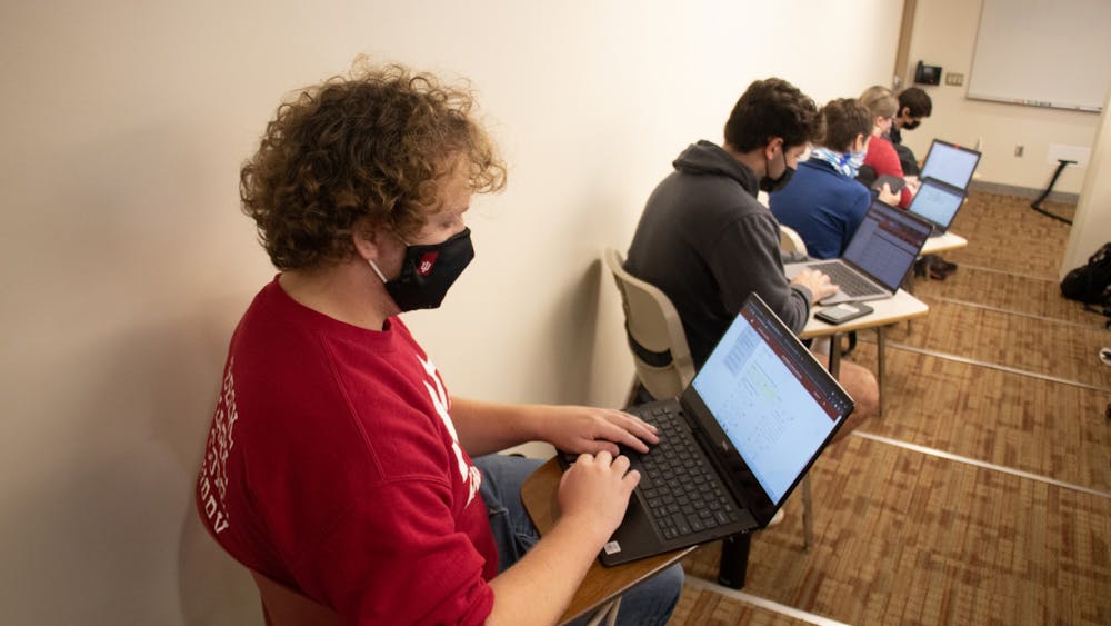 Junior Corbin Dubois looks at his computer during a class on Oct. 21, 2021, in Franklin Hall. Instructors and presenters can now unmask while social distancing in the classroom.