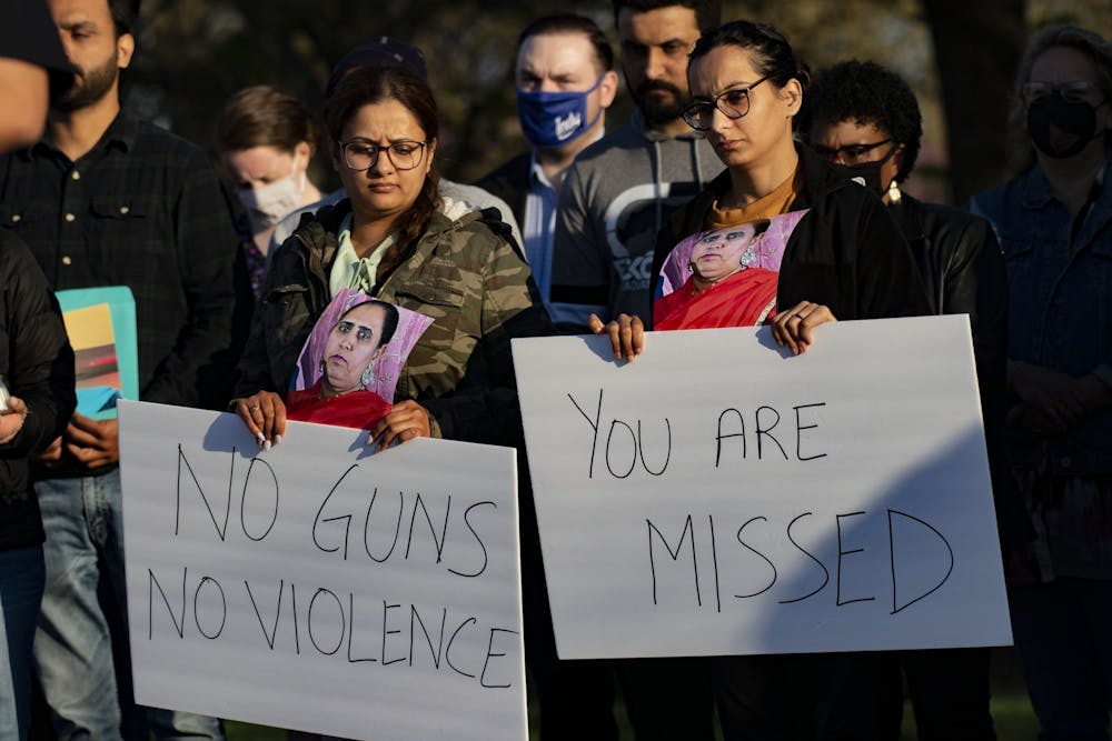 <p>Attendees of a vigil in honor of those killed at the FedEx Ground shooting hold signs April 16, 2021, at Krannert Park in Indianapolis. Family members of the victims filed a lawsuit against FedEx for negligence.</p>