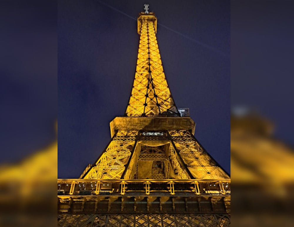 <p>The Eiffel Tower in Paris, France glitters on a rainy night.</p>