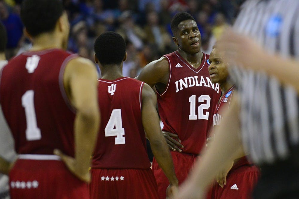 Junior Hanner Mosquera-Perea and his teammates gather around him after Perea was called for a foul during IU's game against Wichita State on Friday at CenturyLink Center in Omaha, Neb.