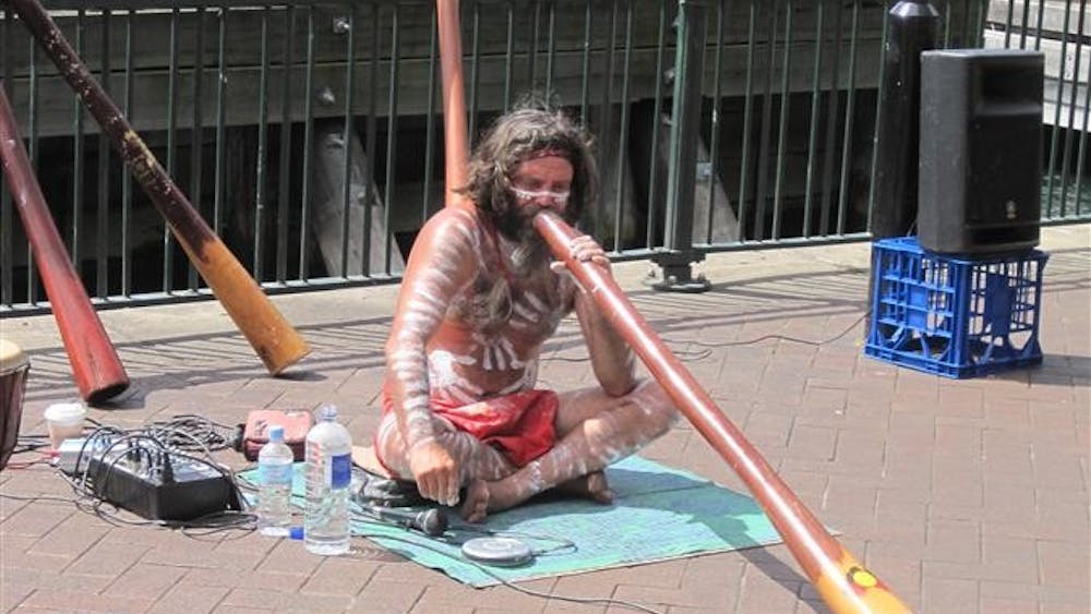SYDNEY – An Aboriginal man plays the uluru, a native instrument, near Sydney Harbor. Crave Sydney, an art and culture festival celebrated throughout October, attempts to reconcile Australia’s original inhabitants – the Aboriginals – with its immigrant European population.