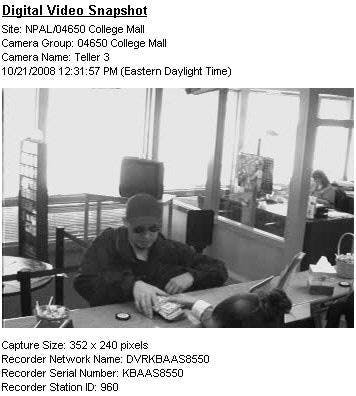 This digital video snapshot, taken from a security camera at Fifth Third Bank, shows the bank teller handing money to the robber.  The robbery happened at 12:33 p.m. on Tuesday.