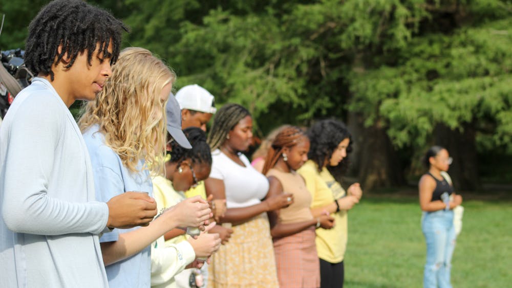 Students have a moment of silence in remembrance of Nate Stratton on Sept. 17, 2023, in Dunn Meadow. The Nate Stratton Celebration of Life event was held from 4 p.m. to 6 p.m. with live music, remarks about Stratton’s impact and a candlelight vigil.
