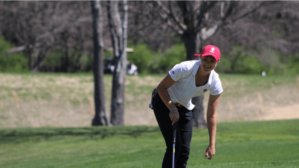 Then-freshman, now junior Emma Fisher picks her ball out of the hole after sinking a putt April 8, 2017, during the IU Invitational at the IU Golf Course. IU will compete in the Big Ten Tournament on April 19-21 in Maineville, Ohio. 