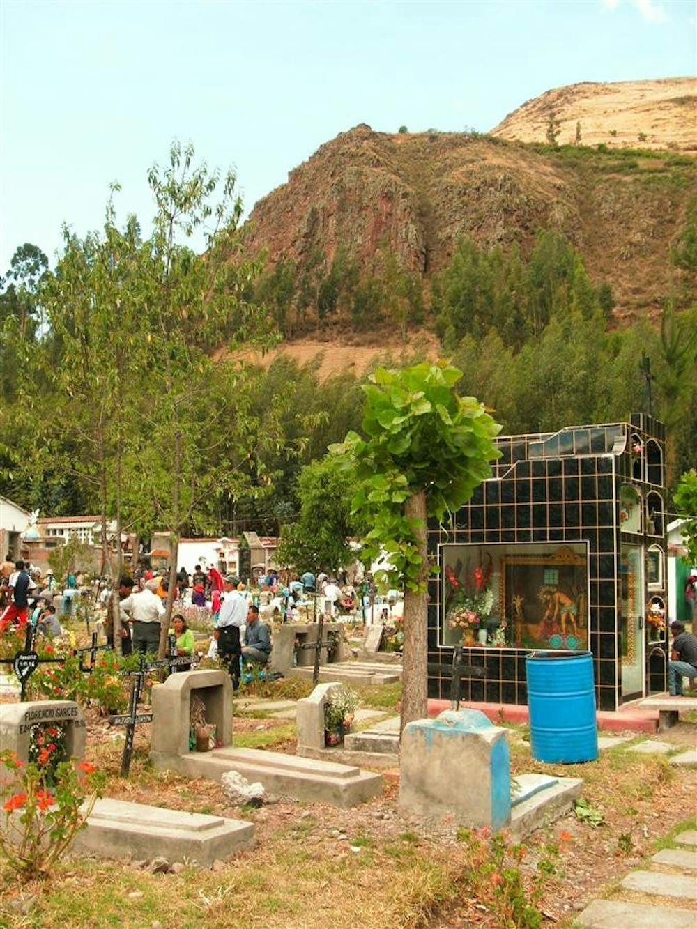 A crowd of vendors and families celebrate outside the entrance to the graveyard "Jardines de la Paz," or "Gardens of Peace," in Calca, Peru, for the Nov. 2 Day of the Dead holiday.