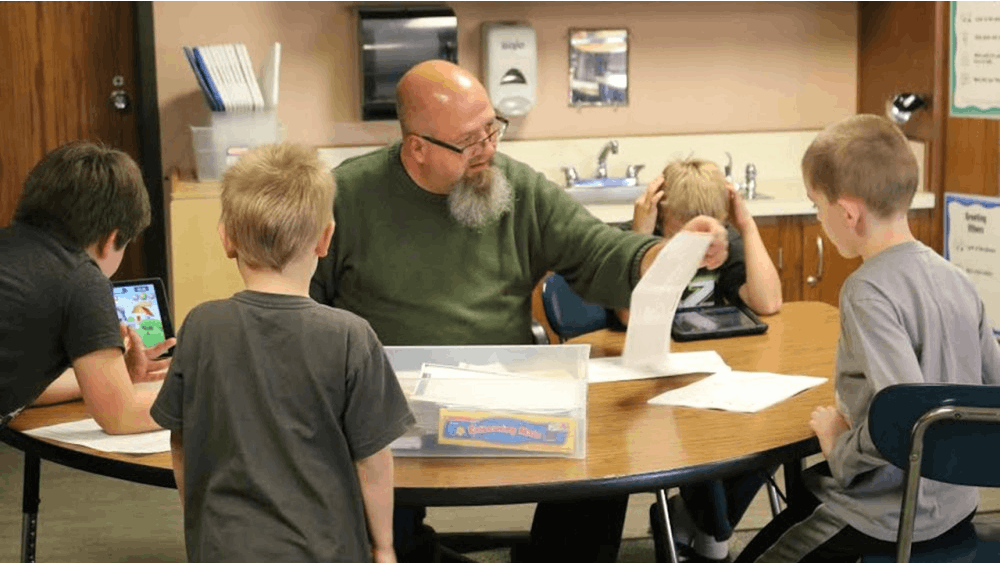 Special education teacher at Highland Park Elementary School Kraig Bushey works with students in the classroom on focusing skills to prepare them for traditional classrooms in the future. 