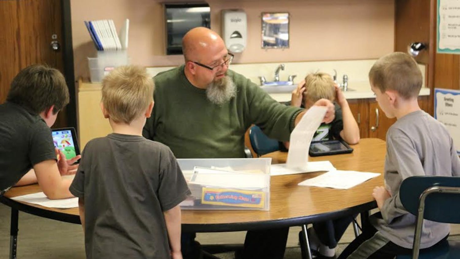 Special education teacher at Highland Park Elementary School Kraig Bushey works with students in the classroom on focusing skills to prepare them for traditional classrooms in the future.