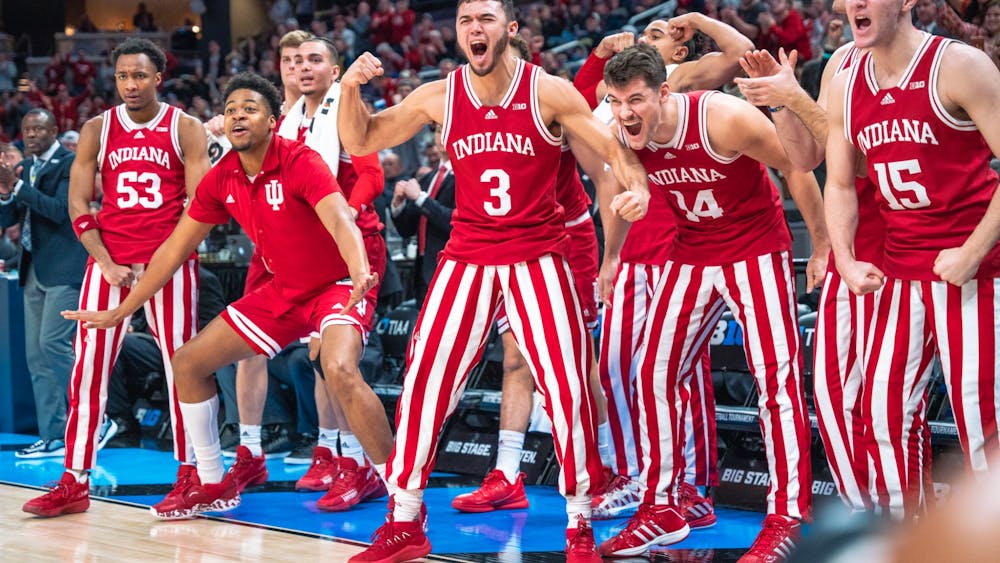 The Indiana bench reacts to a 24-4 run March 10, 2022, at Gainbridge Fieldhouse in Indianapolis. IU won 74-69 against Michigan.